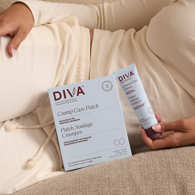 DIVA Cramp Care Patch and creamheld by a person on a beige couch